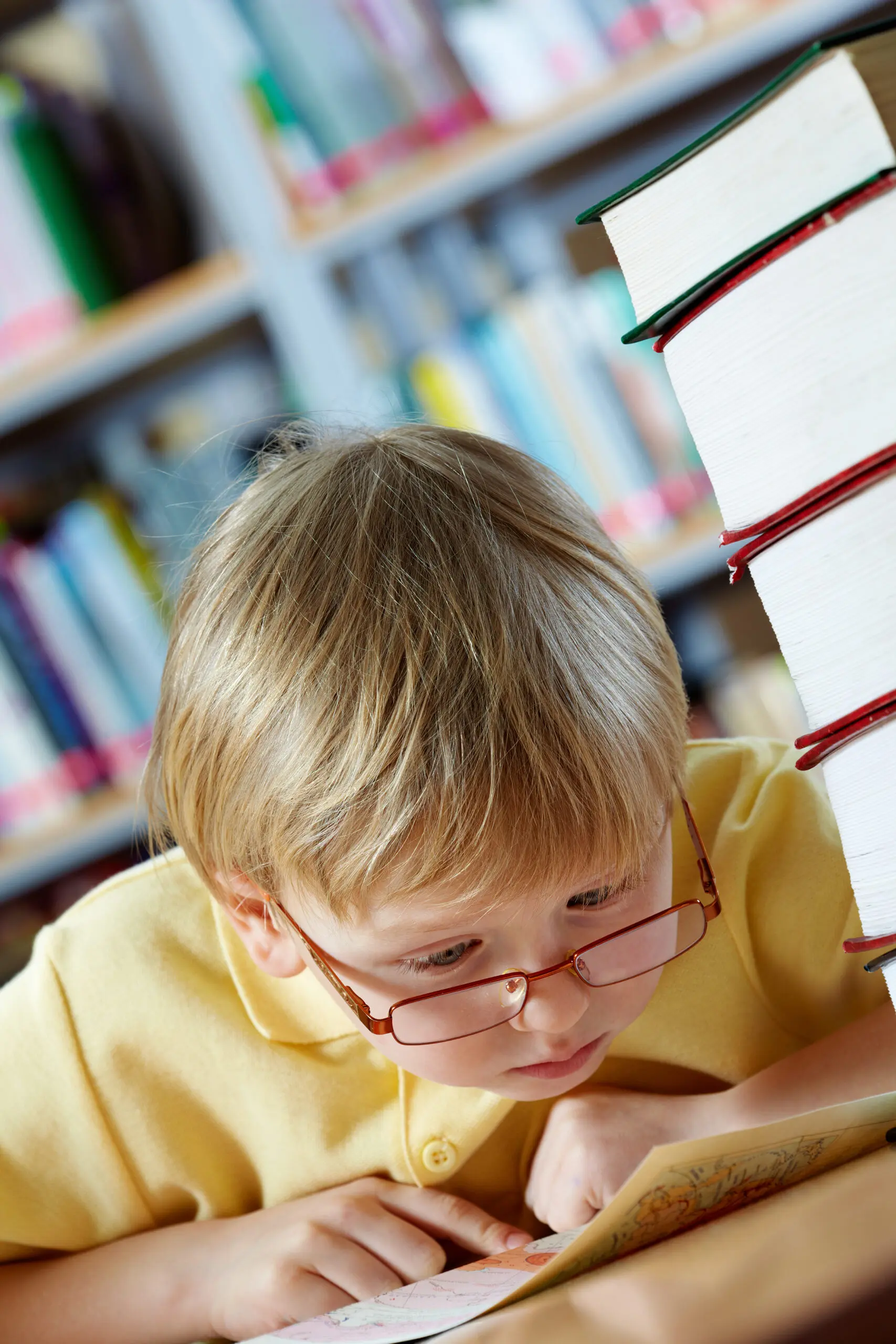 Boy reading close to his face, a common signs of a vision problem in kids