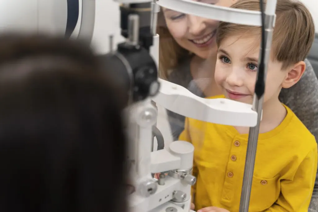 Young boy having his eye health checked with a slit lamp during a kids eye exam