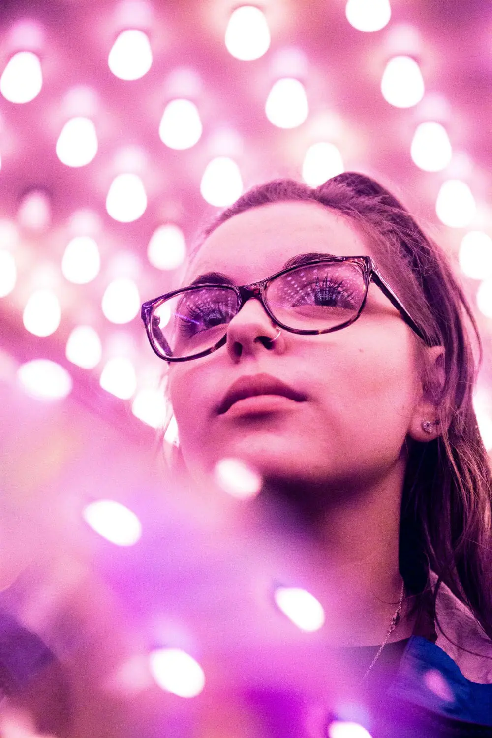 Woman with pink glasses - eyewear selection at Maple Grove Eye Doctors