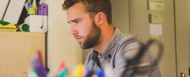 Man working at computer Maple Grove Eye Doctors at Pearle Vision