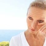 Woman with red eyes - symptoms of eye irritation Maple Grove Eye Doctors